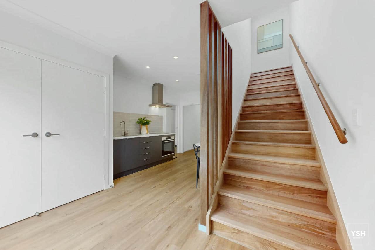 Rooming House Common Area – Kitchen and Staircase | 54 Tavistock St Modern shared kitchen and staircase in rooming house at 54 Tavistock Street – functional layout with stylish timber finishes.