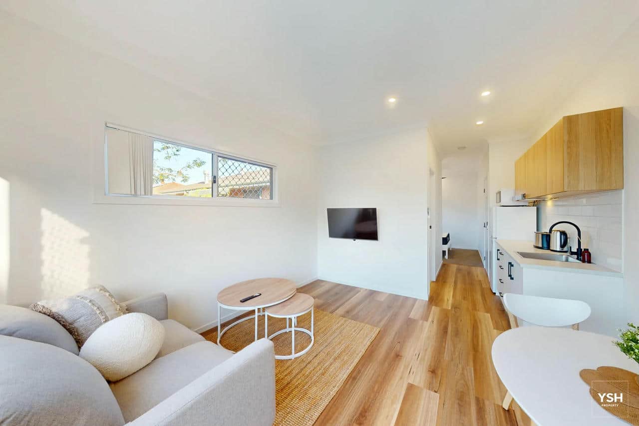 Rooming House Unit Interior – Open Plan Living and Kitchen Interior of a modern rooming house unit with integrated living, kitchen and TV area – designed for comfort and functionality.